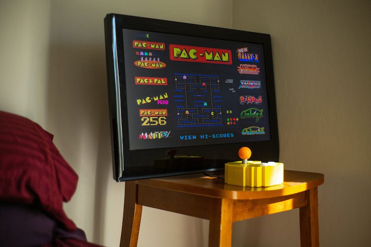 A monitor shows the game Pac-Man.